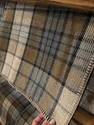 Close up texture of Pendleton Eco-Wise wool blanket fabric and whipstitched border
